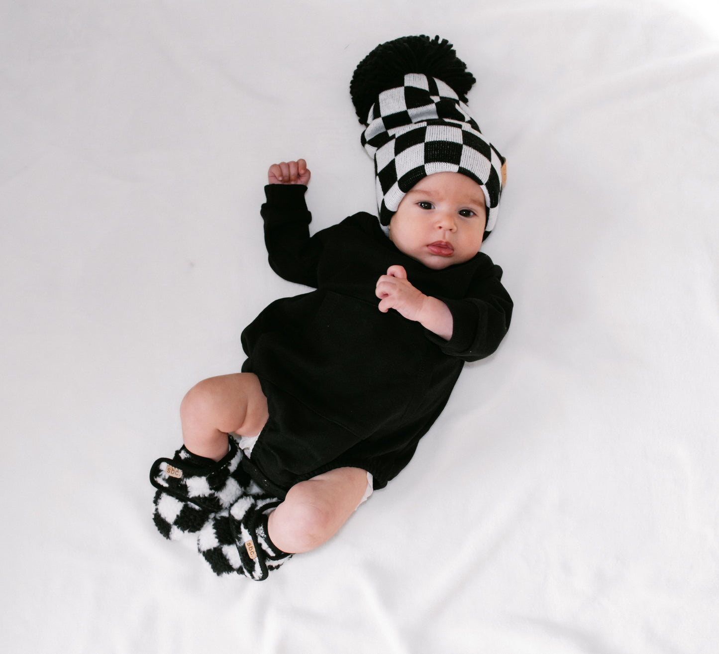 The Newborn Sherpa Bootie — Black + White Checkered